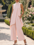 Close-up on the wide-leg hem of the lake blue jumpsuit, showing the impeccable drape of the fabric.