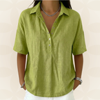 Close-up detail of the front button closure and sophisticated collar on a light blue shirt.