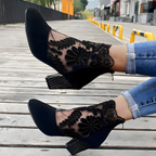 A woman walking confidently in black leopard orthopedic heels, illustrating the natural alignment and pain relief.