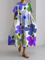 Woman enjoying a sunny day outdoors, wearing a flattering blue floral dress with an adjustable waist.