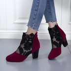 Front view of a pair of black orthopedic heels, displaying the breathable material and stylish finish.