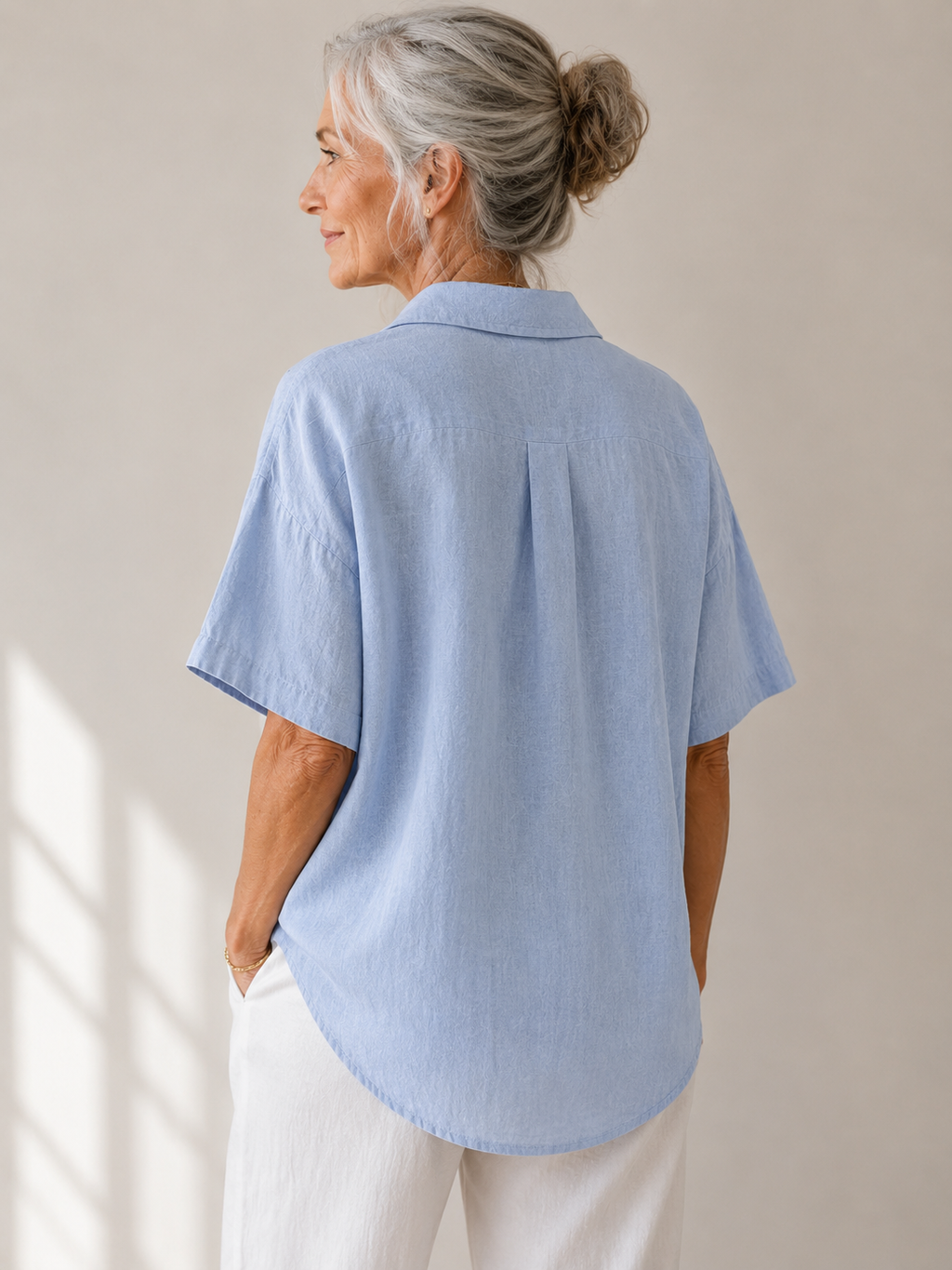 Full length view of a white short-sleeved shirt, perfect for a relaxed yet polished ensemble.