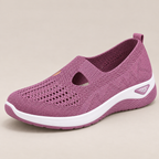 Rear view of the sturdy heel support on a pair of grey sneakers, providing stability details.