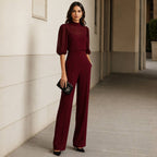 Back view of the sheer sleeve blouse, showing the graceful drape of the fabric and the subtle button closure.
