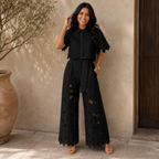 Rear perspective of the light blue trousers, emphasizing the relaxed drape and comfortable silhouette.