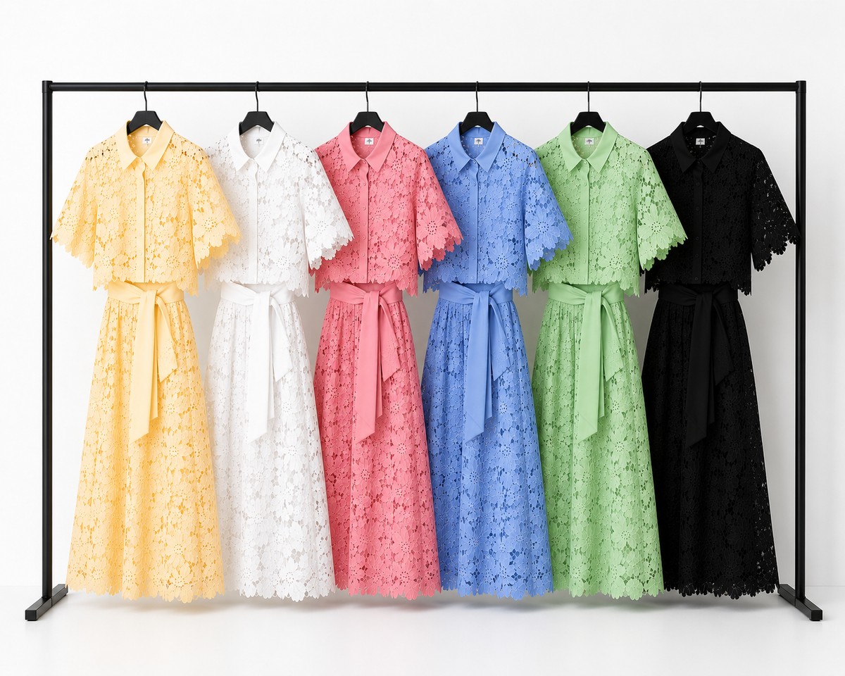 Three pairs of Aurelia trousers in white, black, and pink, displayed on a hanger, ready for selection.