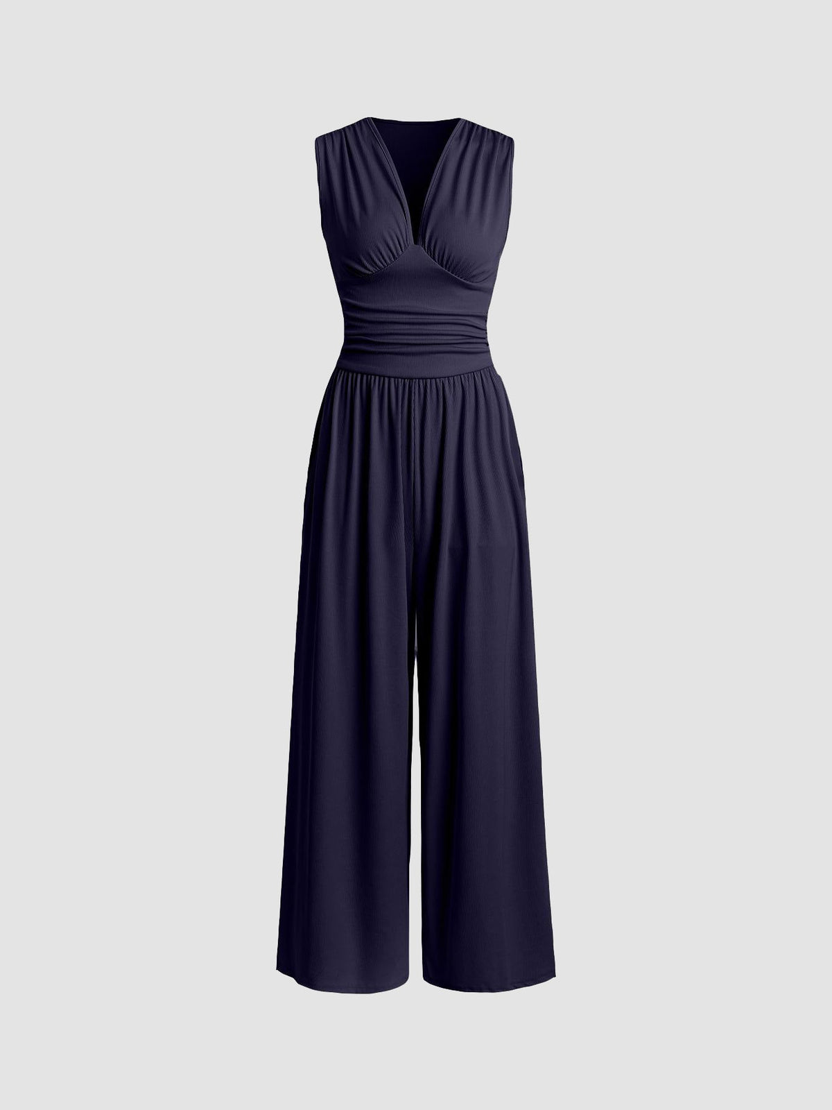 Full-length side view of the camel party jumpsuit, emphasizing the sculpted fit through the waist and relaxed trousers.