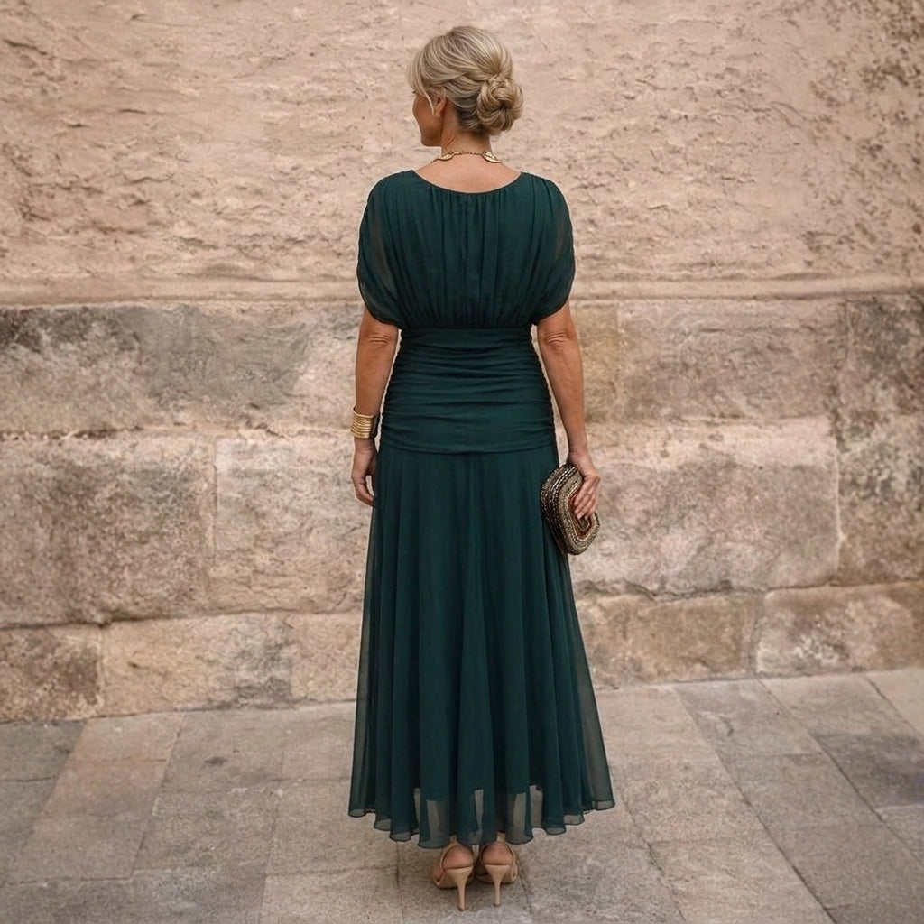 Close-up detail of the criss-cross off-shoulder neckline on the sophisticated maxi dress.