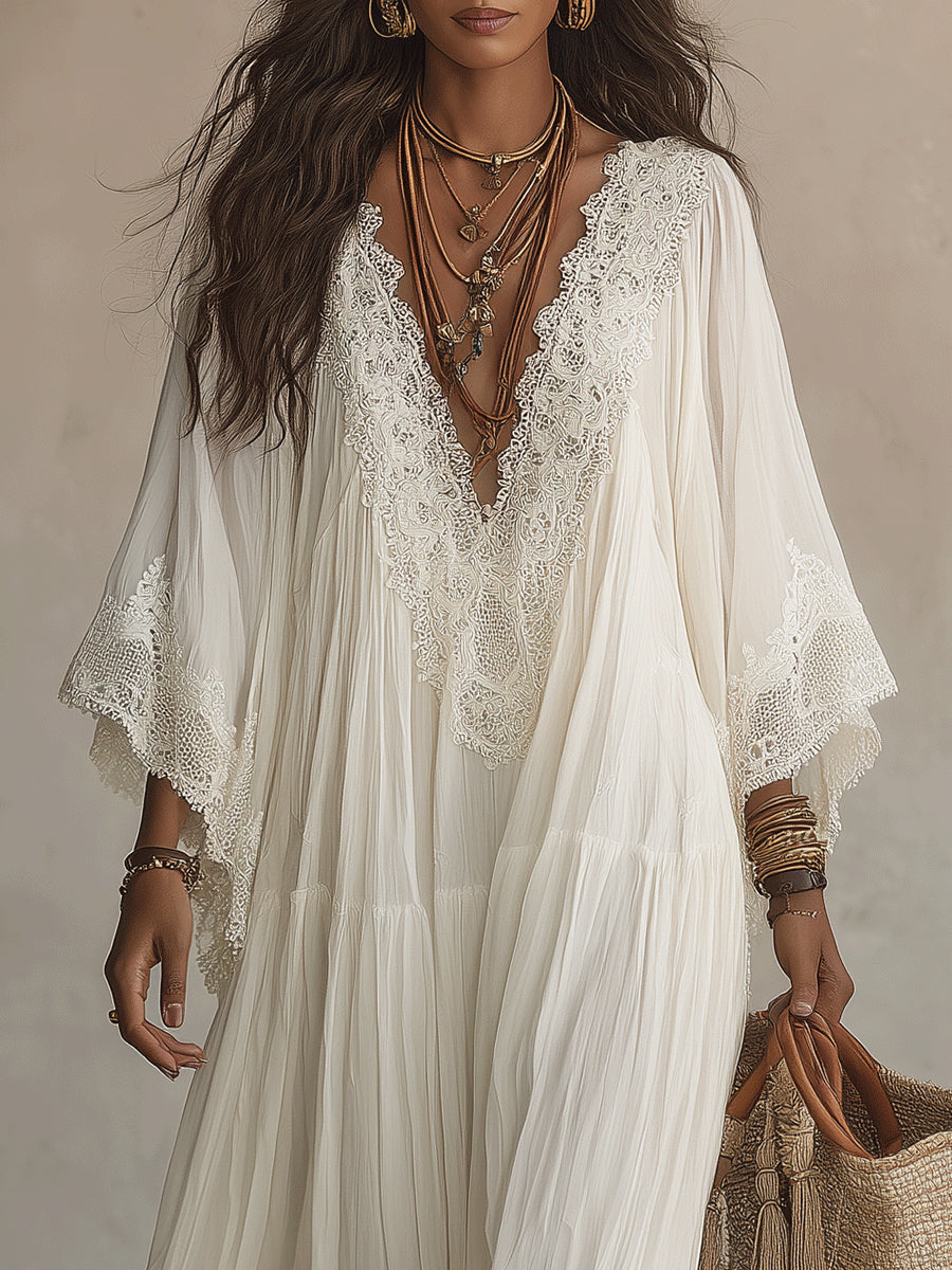 Back view of the long ivory batwing dress, highlighting its natural pleats and full, enveloping design.