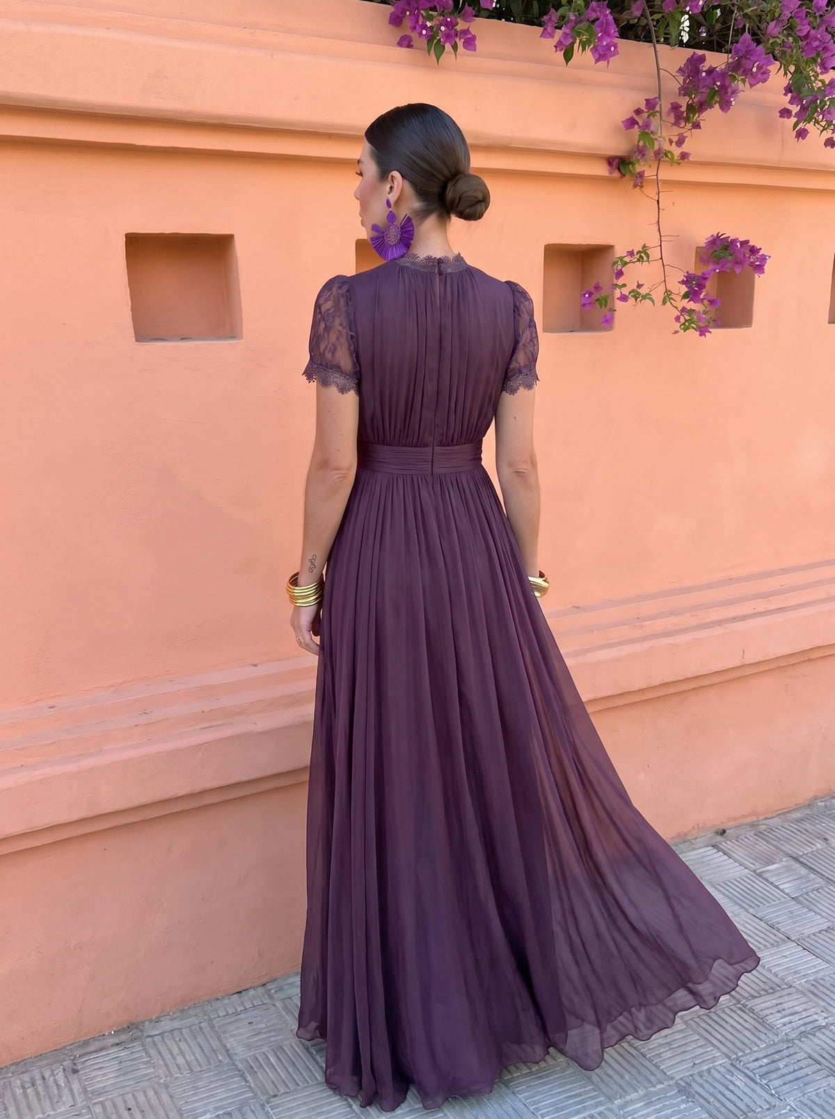 Close-up detail of the high neckline and long sleeves of the stylish chiffon maxi dress.
