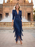 Three-quarter view of the blue dress, capturing the long sleeves and comfortable, relaxed fit.