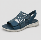 Close-up of the blue walking sandals, highlighting the adjustable strap closure and flexible anti-slip outsole texture.