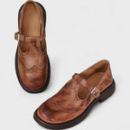 Overhead shot of two pairs of women's shoes, black and brown, showing available color options and their classic style.