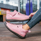 Yellow sneakers on a wooden floor, capturing the vibrant color option and relaxed aesthetic.